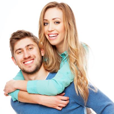 White man and woman hugging, smiling after dental implants, downey ca