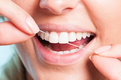 A person flossing their teeth