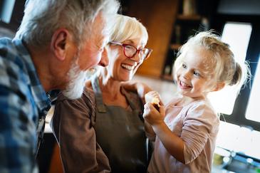 Older man and woman smiling with young girl, Downey CA