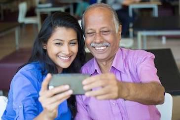 Indian father and daughter smiling and taking a selfie, Downey CA